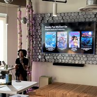 Amara S. speaking alongside a slide titled, "Books I've Worked On"